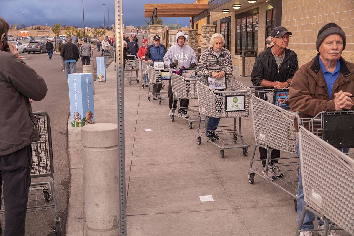 Seniors line up outside of a Smith's Marketplace located at 9710 West Skye Canyon Park Drive in ...