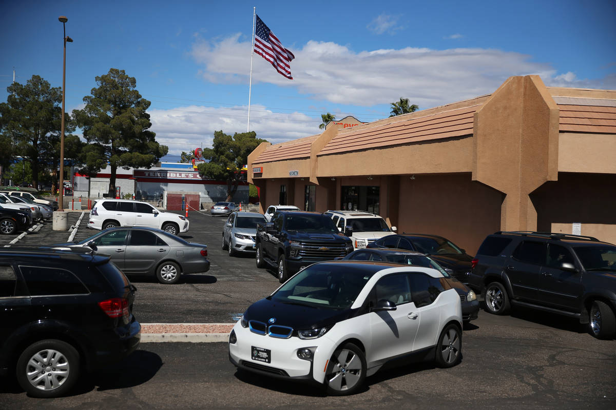 People line up to leave a swab sample at the Sahara Urgent Care & Wellness center in Las Vegas, ...