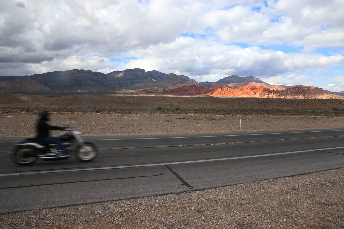 A motorcycle driver makes his way north on Route 159 at Red Rock Canyon in Las Vegas, Saturday, ...
