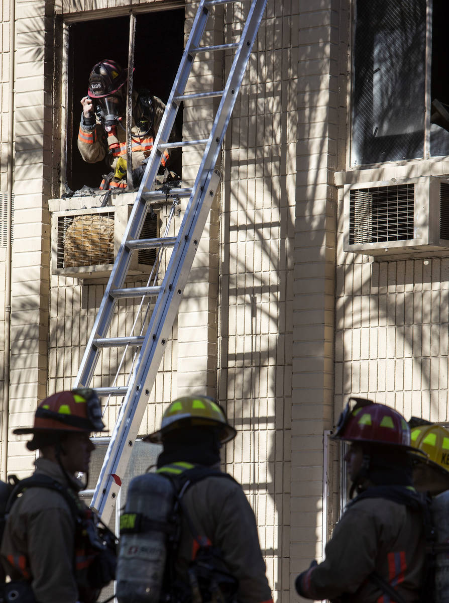 Las Vegas Fire Department firefighters assess the damage after structure fire was put out at 32 ...