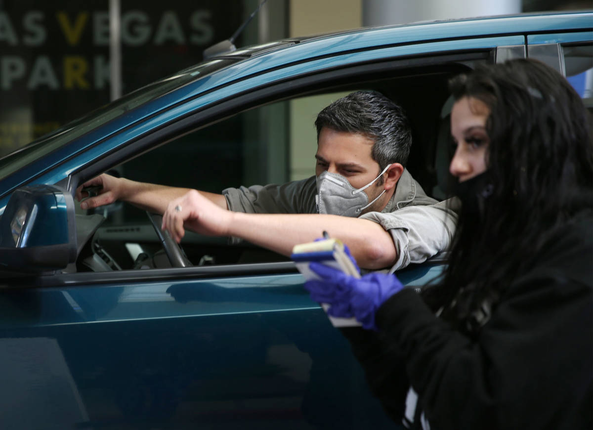 Andrea Leon, right, takes an order from a customer who declined to speak, at the Las Vegas Farm ...