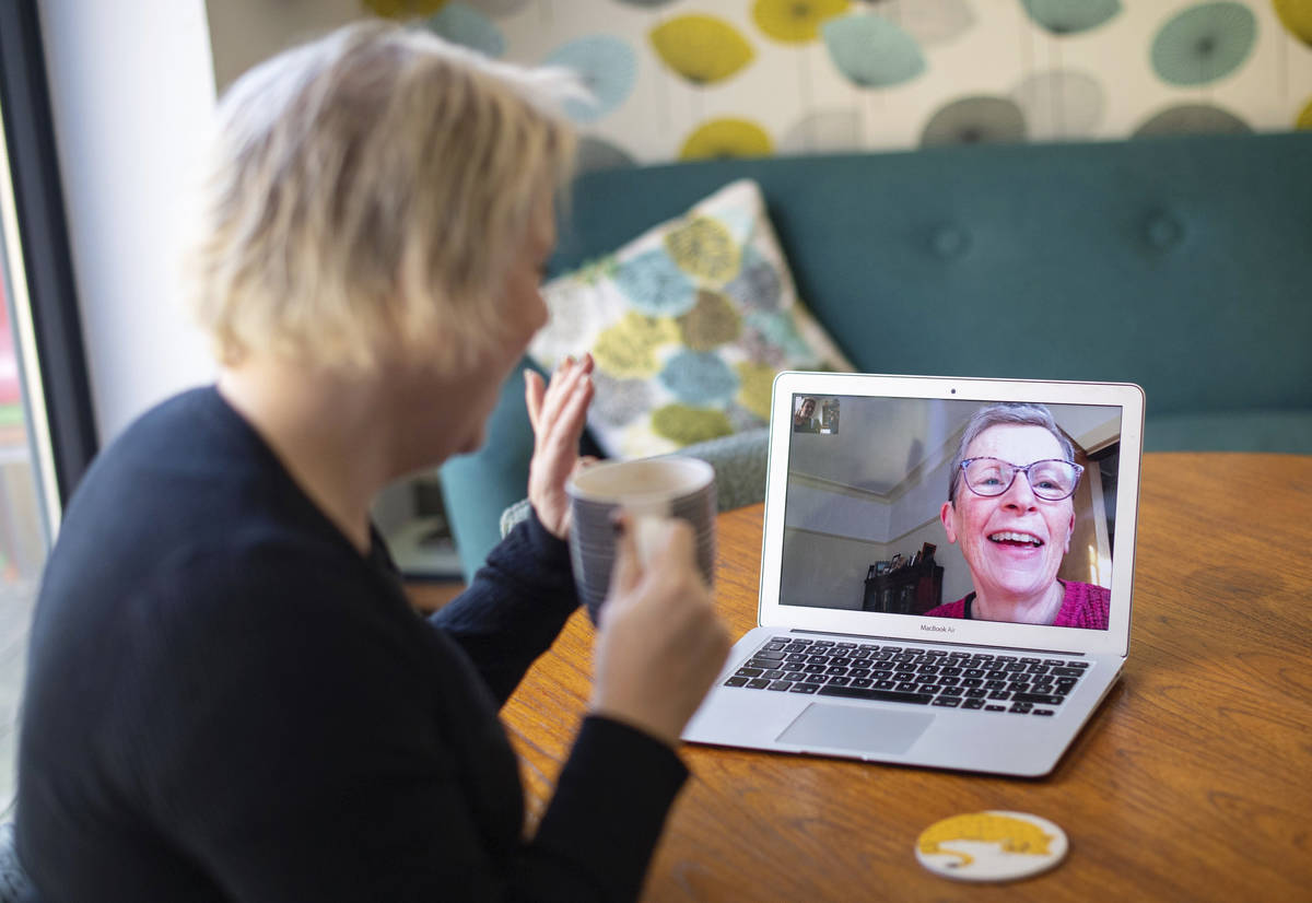 Helen Walters, left, talks to her mother Gillian using video calling, as people find alternativ ...