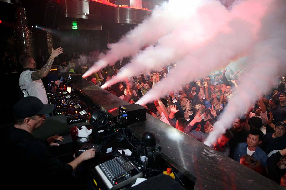 Conventioneers and clubgoers dance to DJ Mark Eteson, upper left, during the CES 2020 official ...