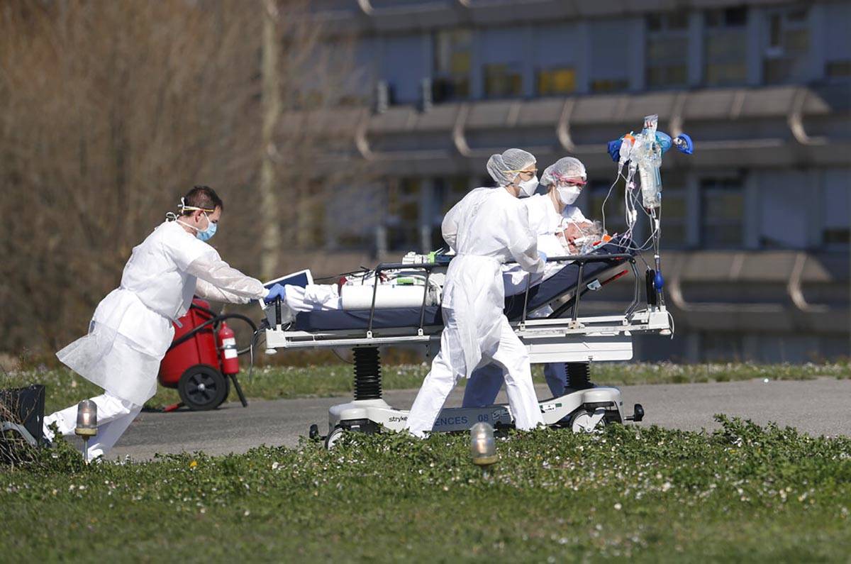 A victim of the Covid-19 virus is evacuated from the Mulhouse civil hospital, eastern France, M ...