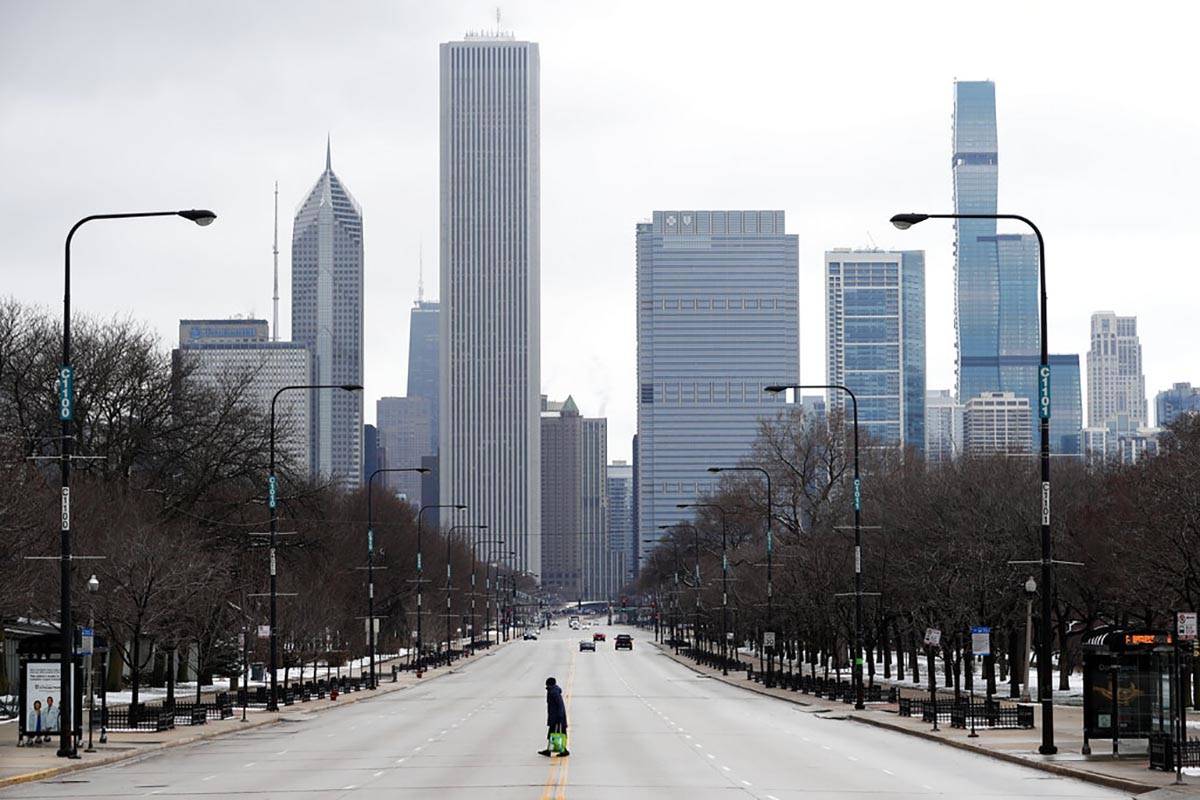 An elderly lady walks across the usually busy Columbus Drive that splits Chicago's Grant Park i ...