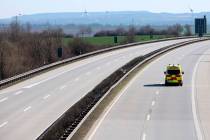 An emergency and rescue car drives on the deserted A4 highway near Erfurt, Germany, Monday, Mar ...