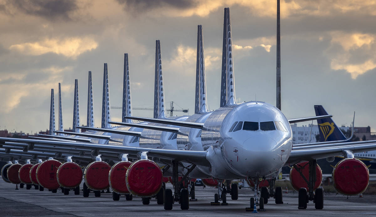 Vueling Airlines planes sit parked in a line at the Seville, Spain airport on Saturday, March 2 ...