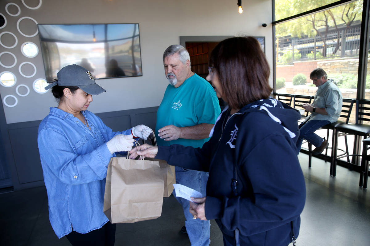 Server Chantasia Holmes, left, fills an order for Leonard and Pat Beloskur of Las Vegas at Loca ...