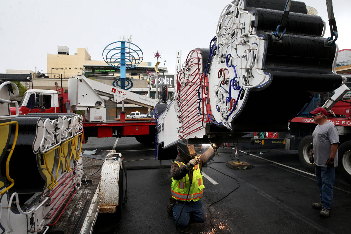 Yesco workers remove the Pabst Blue Ribbon neon sign at Fremont Street and Las Vegas Boulevard ...