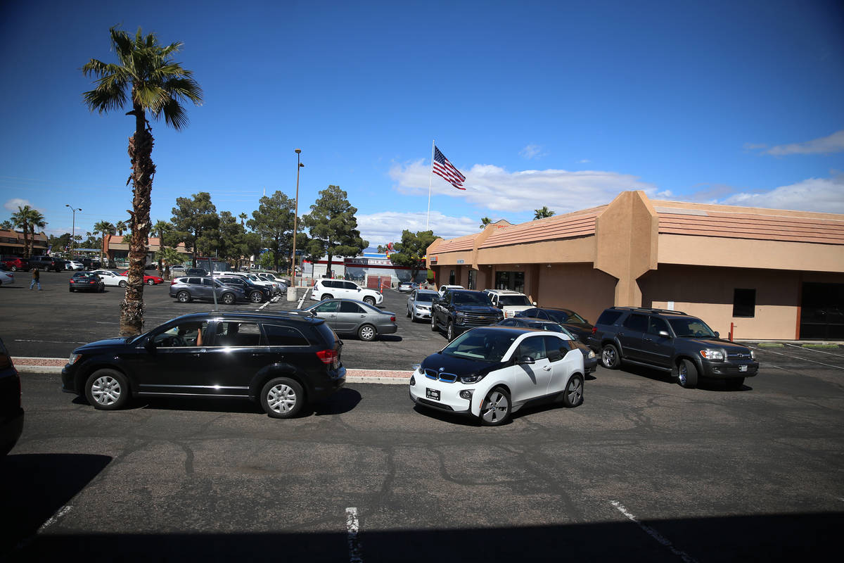 People line up to leave a swab sample at the Sahara Urgent Care & Wellness center in Las Ve ...