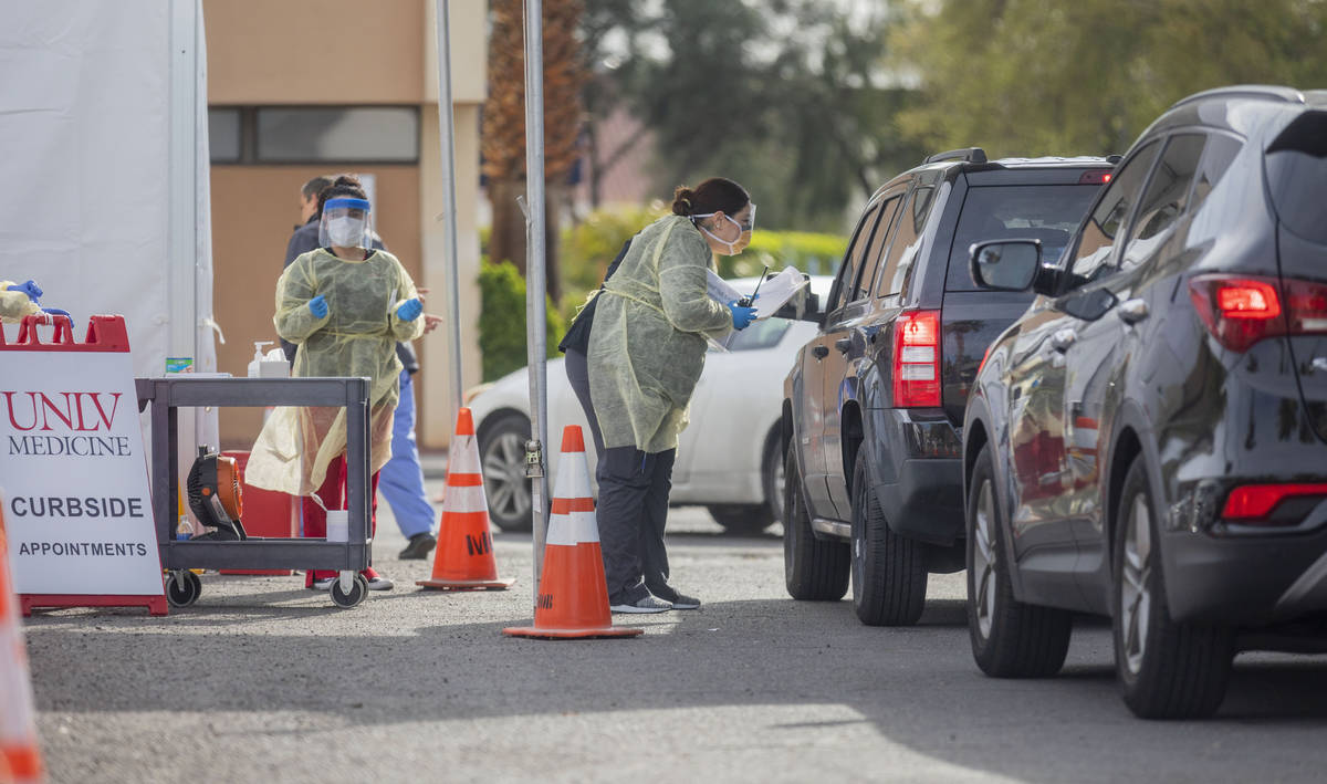 UNLV medicine medical professionals conduct curbside testing on patients experiencing coronavir ...