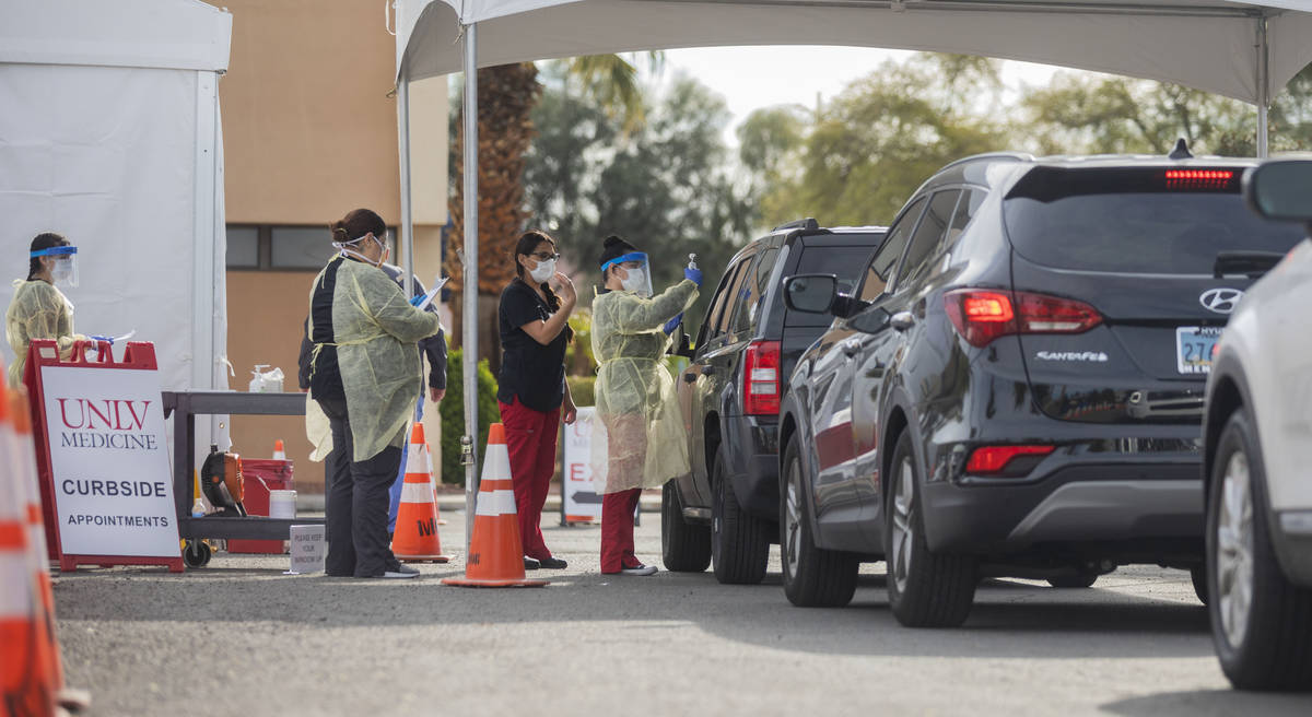 UNLV medicine medical professionals conduct curbside testing on patients experiencing coronavir ...