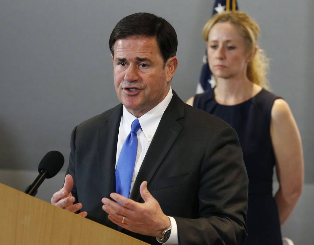 Arizona Gov. Doug Ducey, left, answers a question as he is joined by Arizona Department of Heal ...