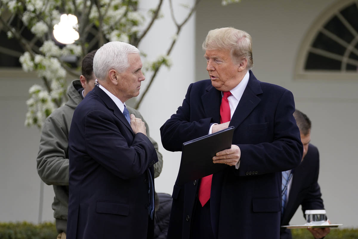 President Donald Trump speaks with Vice President Mike Pence as they arrive for a Fox News Chan ...