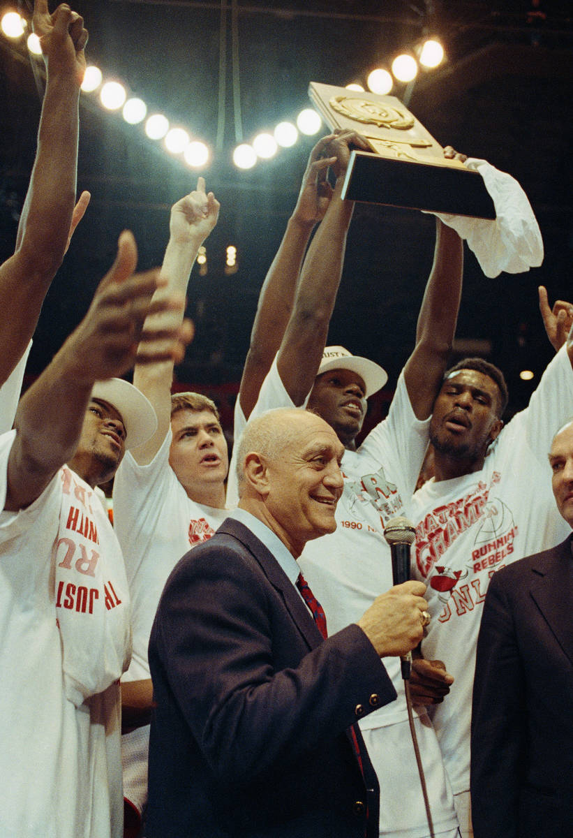 With their NCAA trophy in hand, UNLV coach Jerry Tarkanian and his players celebrate their Fina ...