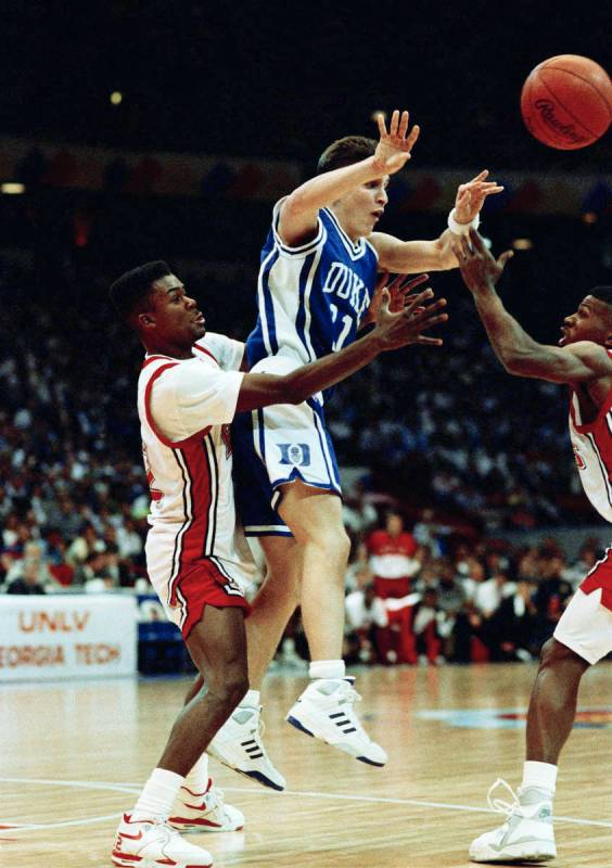 Duke guard Bobby Hurley is trapped by UNLV guard Anderson Hunt (left) and Stacey Augmon (right) ...