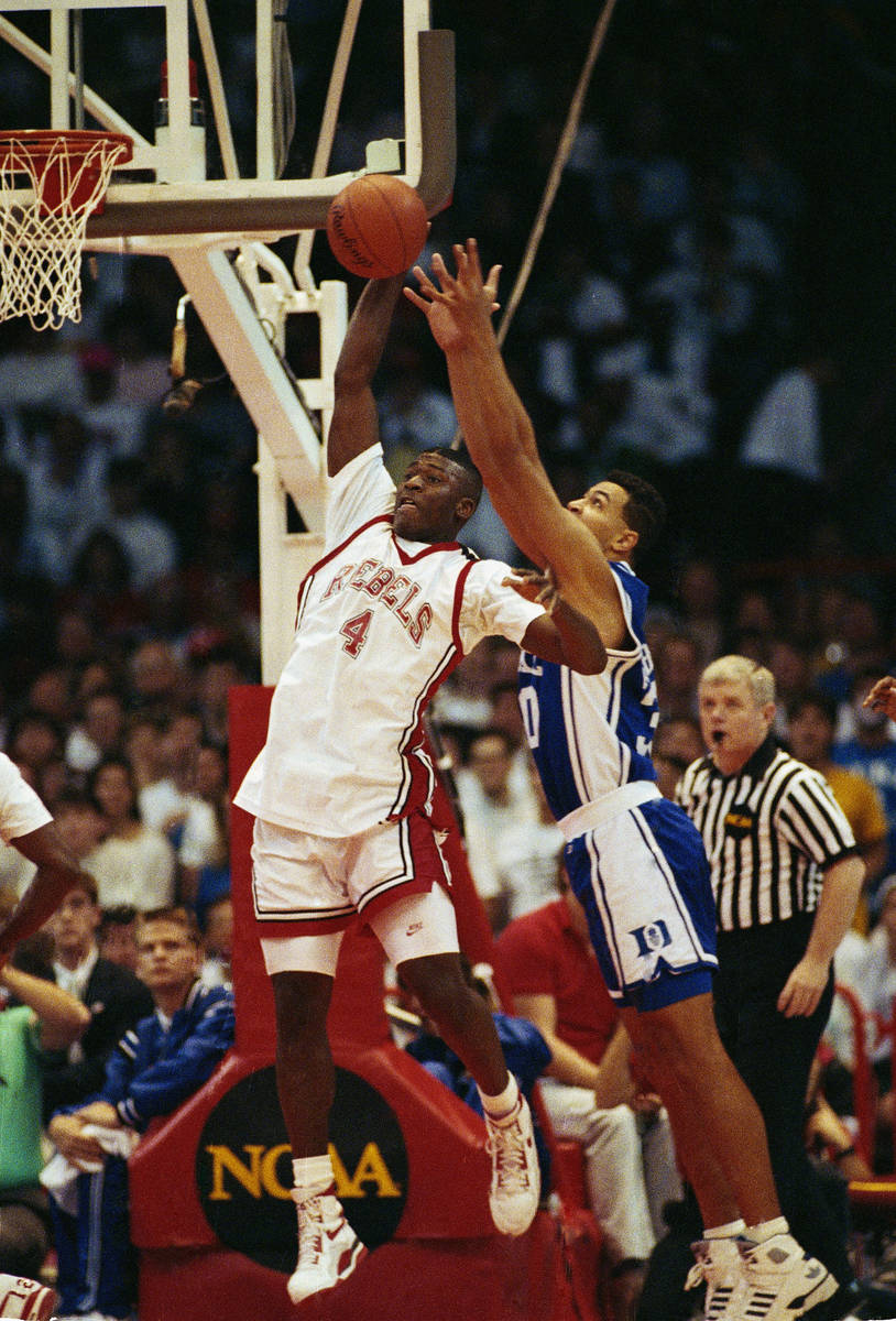 UNLV forward Larry Johnson gets set to fire off a shot beyond the defensive reach of Duke's Ala ...