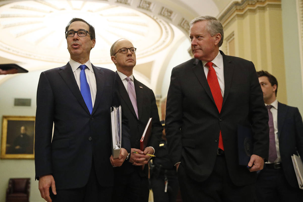 Treasury Secretary Steven Mnuchin, left, accompanied by White House Legislative Affairs Directo ...