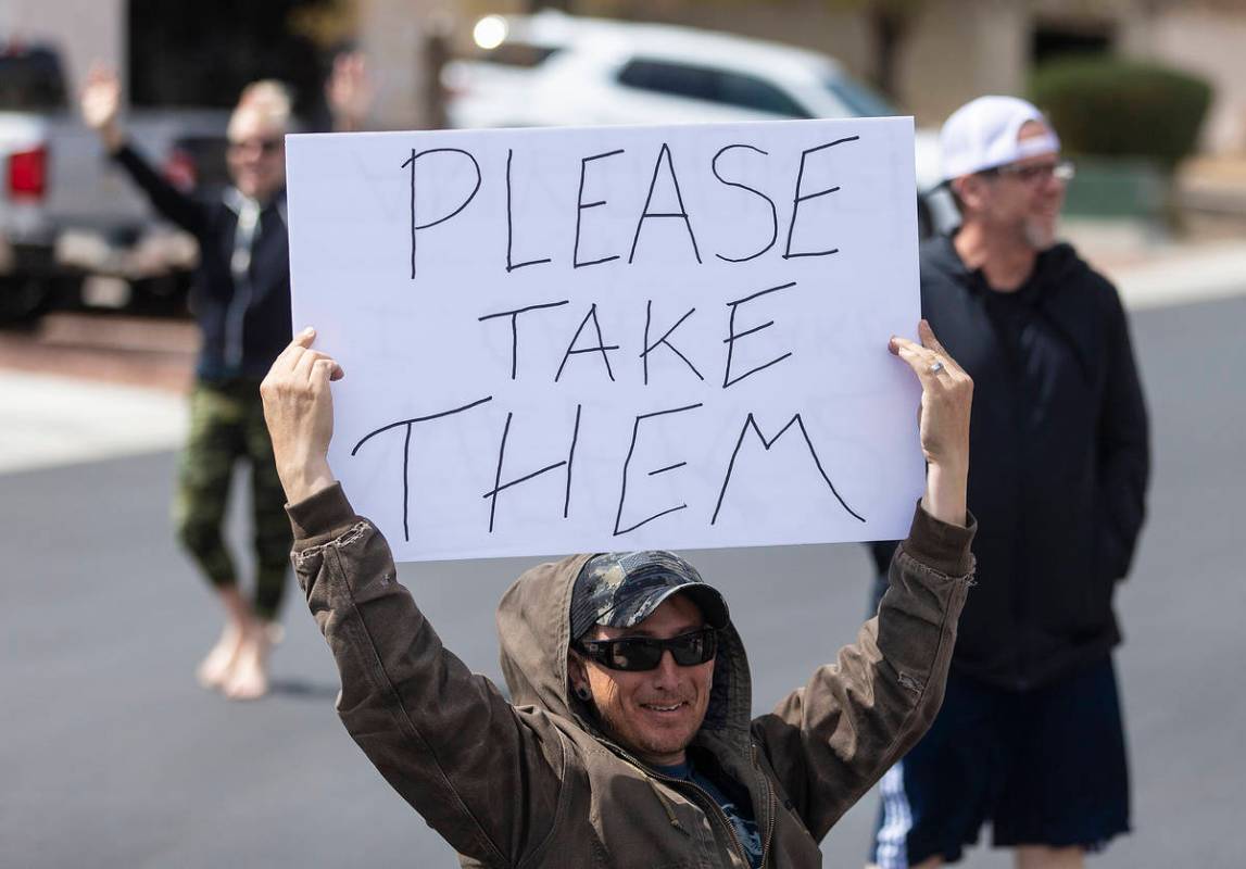 Las Vegas residents wave to teachers and staff from O’Roarke Elementary School who organized ...