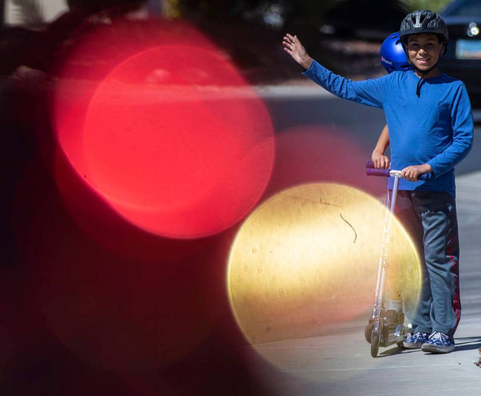 Las Vegas residents wave to teachers and staff from O’Roarke Elementary School who organ ...