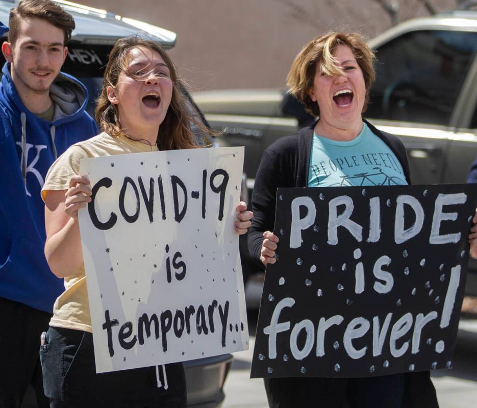 Las Vegas residents wave to teachers and staff from O’Roarke Elementary School who organ ...