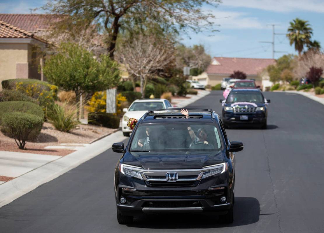 Teachers and staff from O’Roarke Elementary School wave to residents during a parade the ...