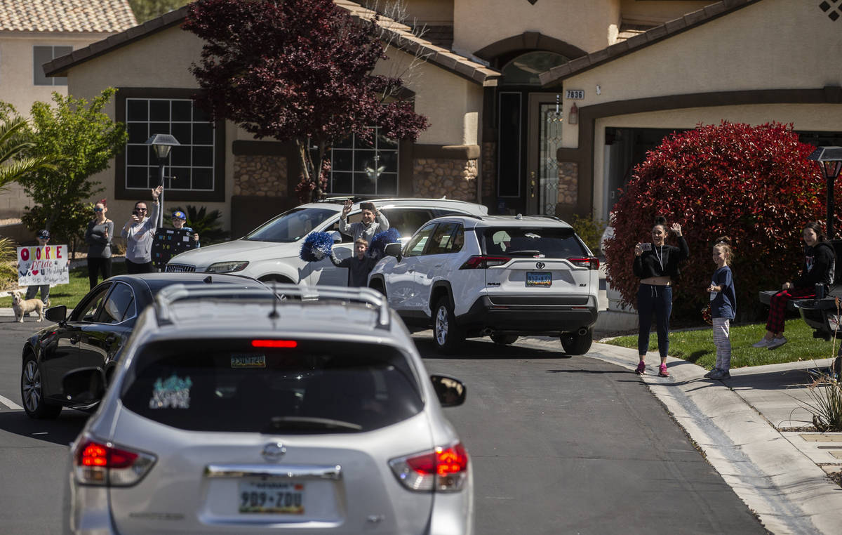 Las Vegas residents wave to teachers and staff from O’Roarke Elementary School who organ ...