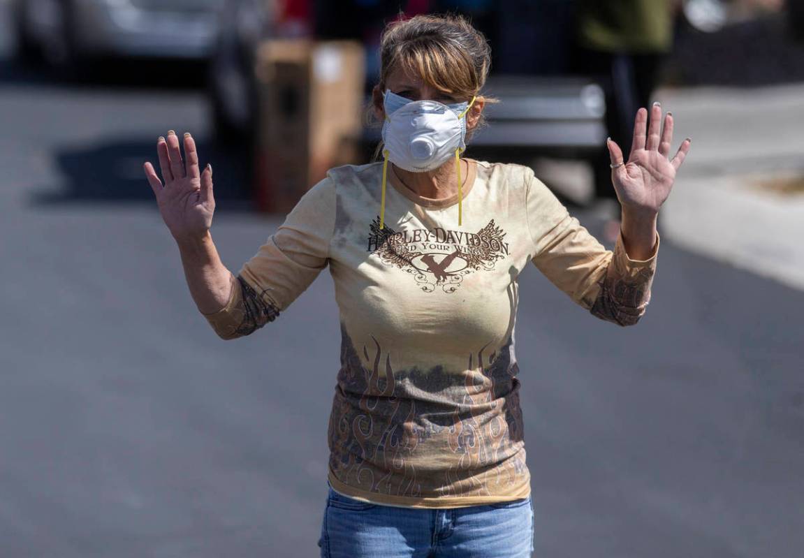 Las Vegas residents wave to teachers and staff from O’Roarke Elementary School who organ ...