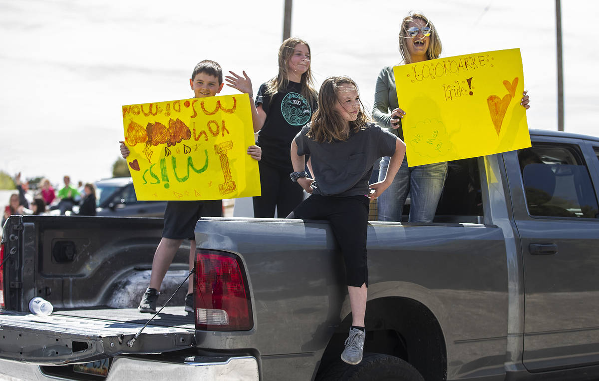 Las Vegas residents wave to teachers and staff from O’Roarke Elementary School who organ ...