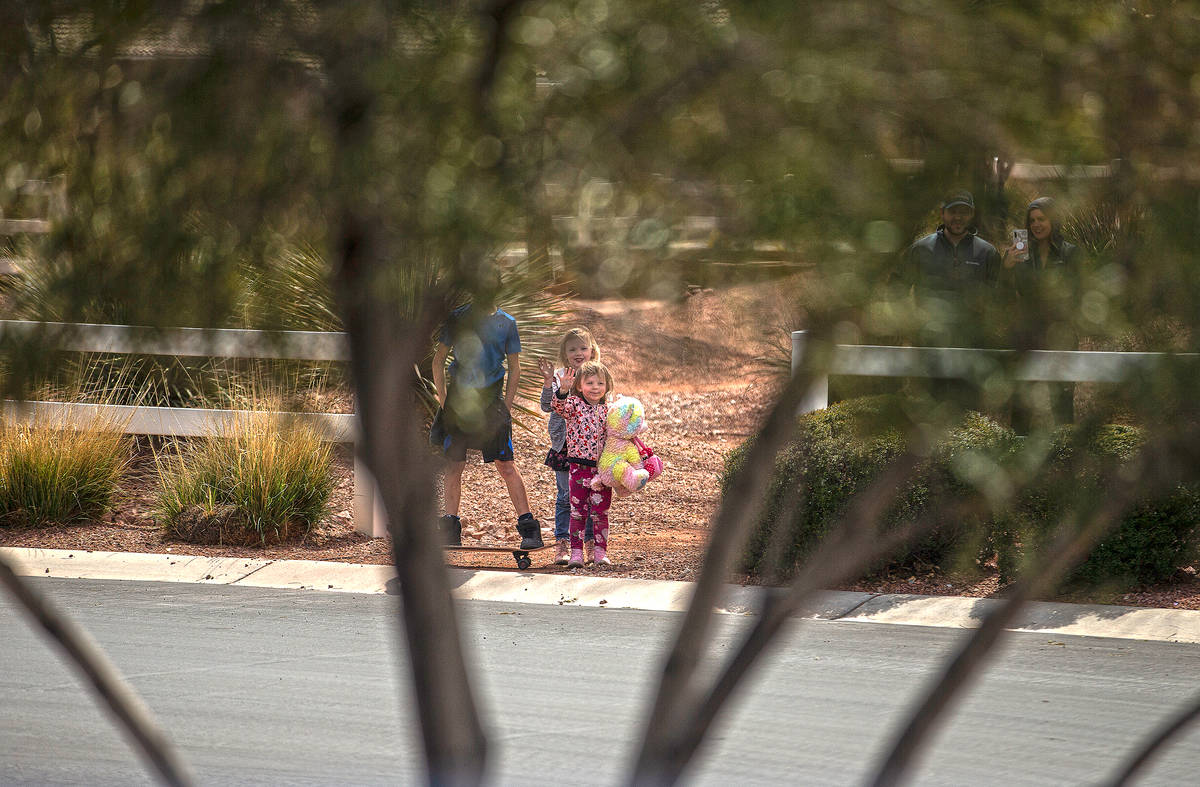 Las Vegas residents wave to teachers and staff from O’Roarke Elementary School who organ ...