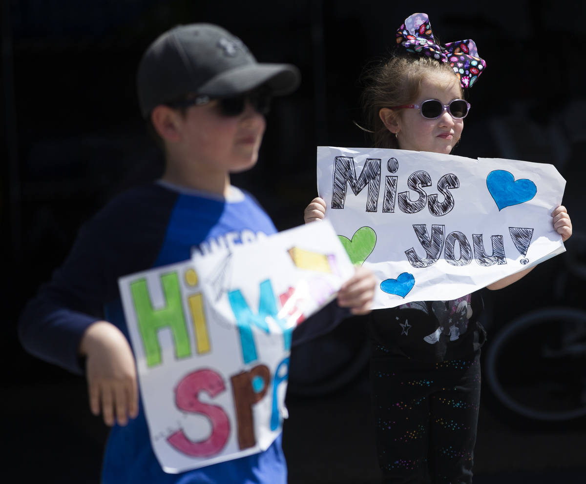 Las Vegas residents wave to teachers and staff from O’Roarke Elementary School who organ ...