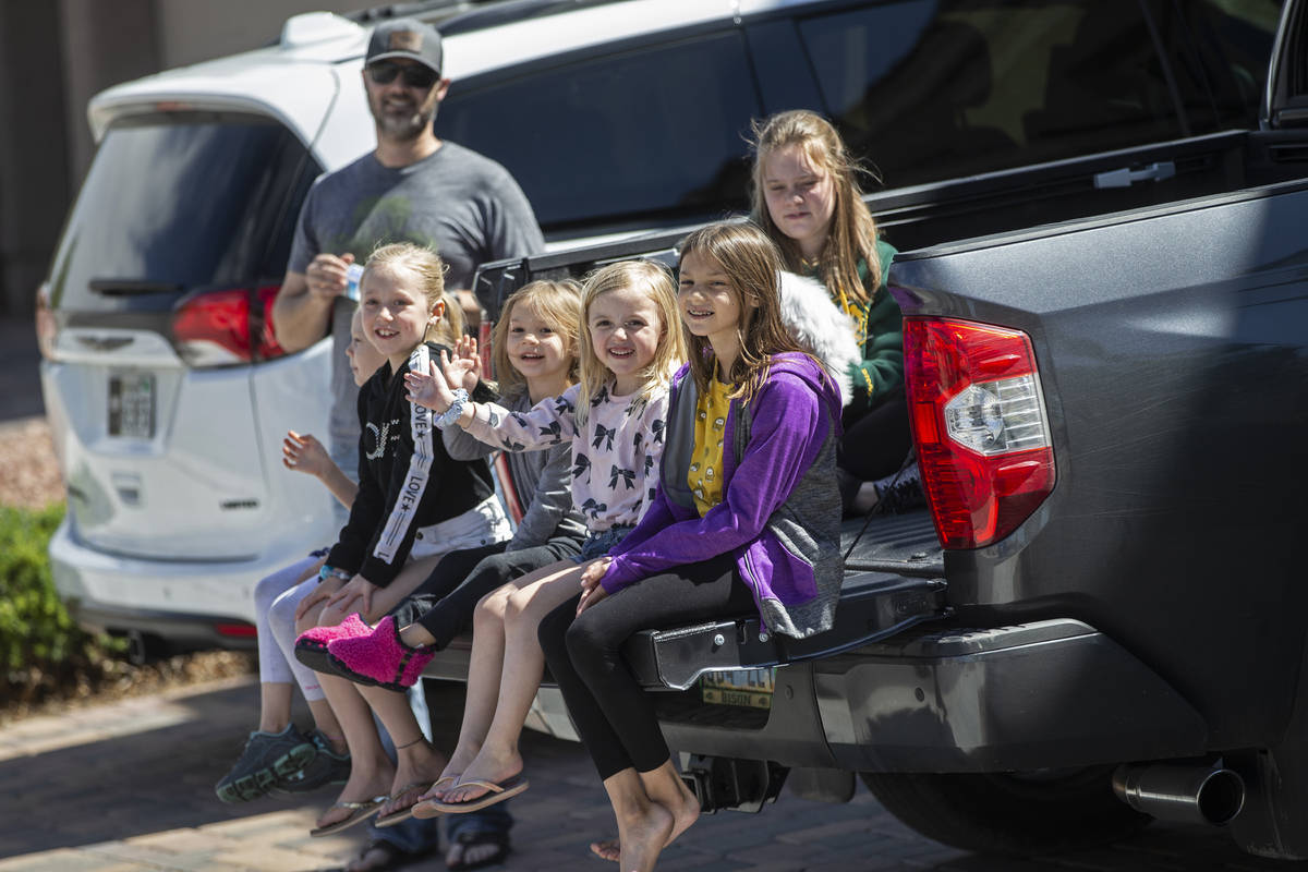 Las Vegas residents wave to teachers and staff from O’Roarke Elementary School who organ ...