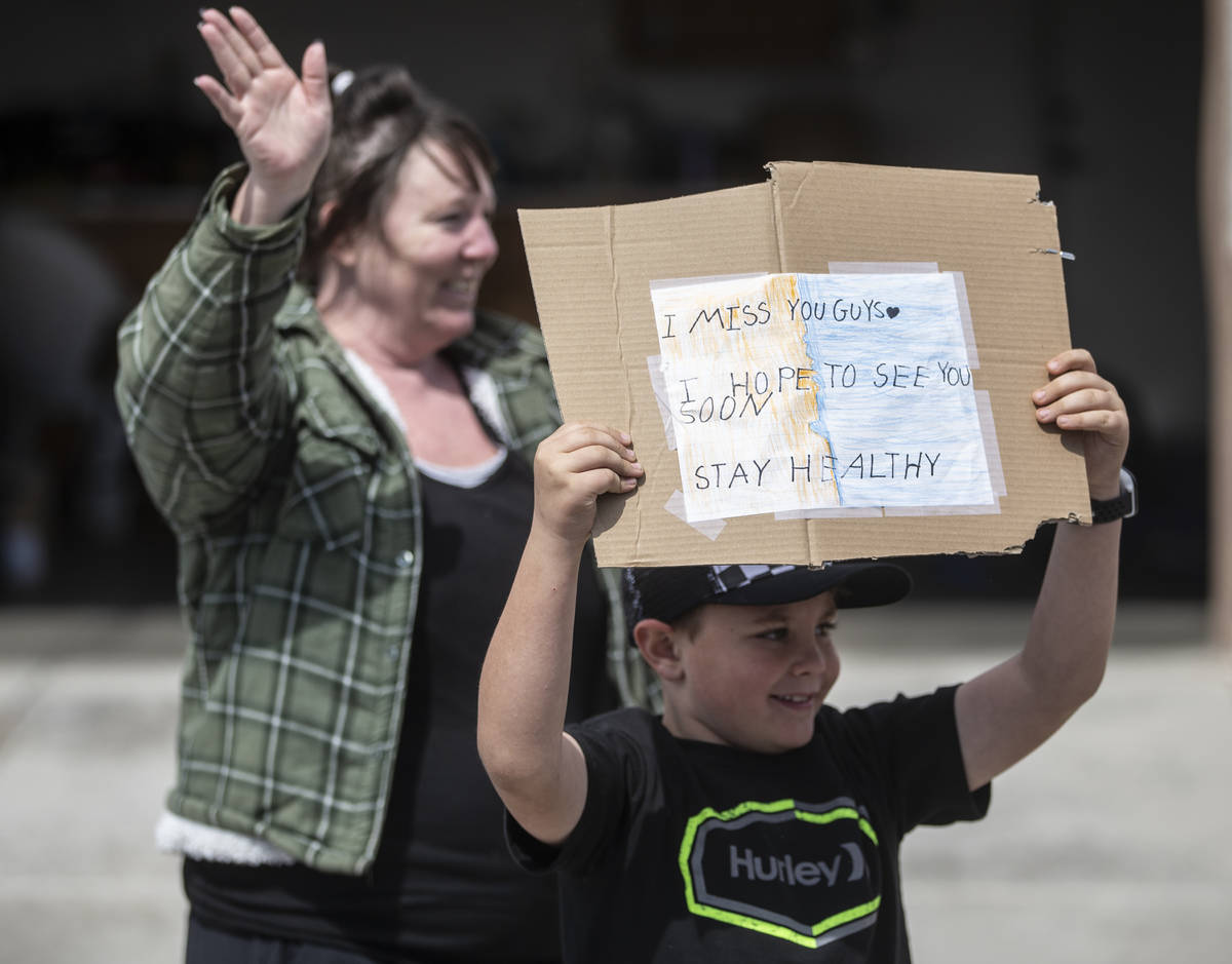 Las Vegas residents wave to teachers and staff from O’Roarke Elementary School who organ ...