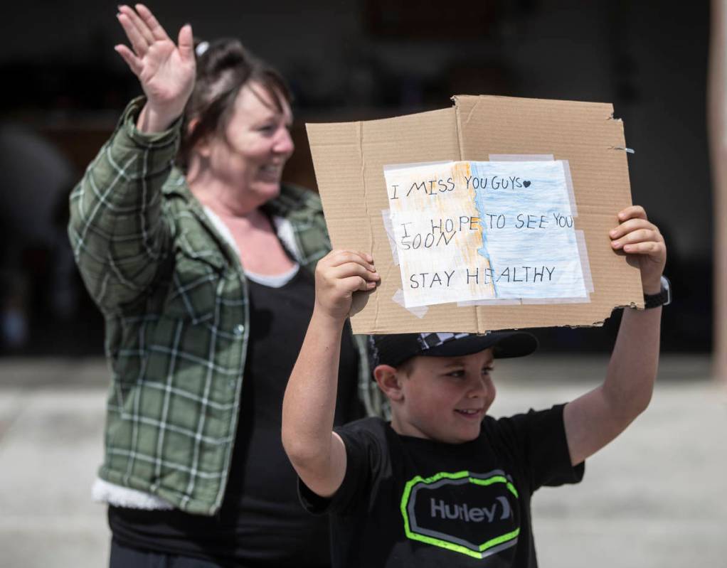 Las Vegas residents wave to teachers and staff from O’Roarke Elementary School who organ ...