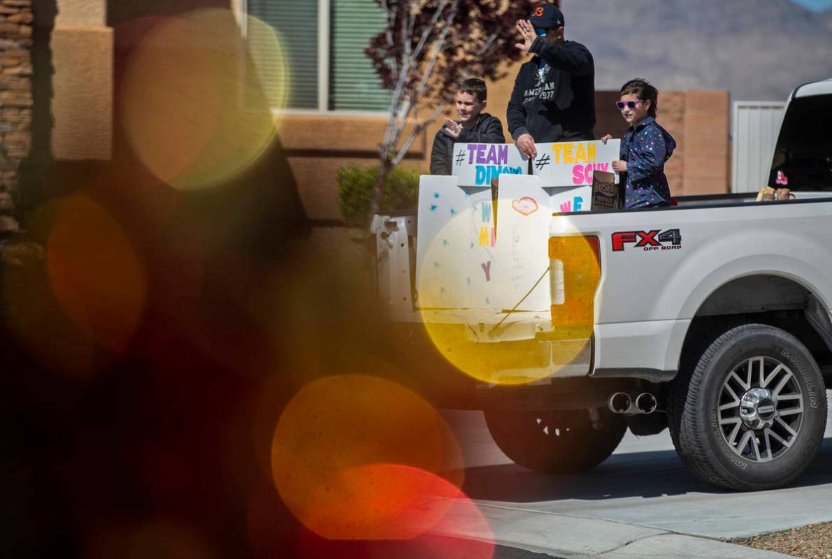 Las Vegas residents wave to teachers and staff from O’Roarke Elementary School who organ ...