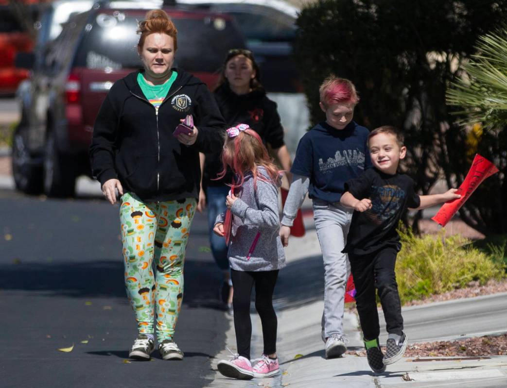 Las Vegas residents wave to teachers and staff from O’Roarke Elementary School who organ ...