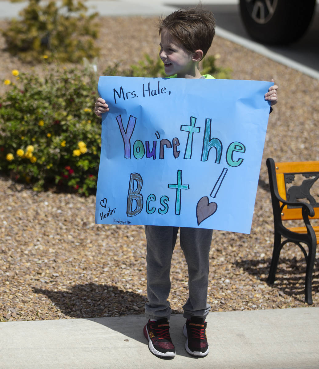 Las Vegas residents wave to teachers and staff from O’Roarke Elementary School who organ ...