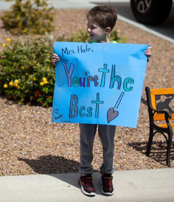 Las Vegas residents wave to teachers and staff from O’Roarke Elementary School who organ ...