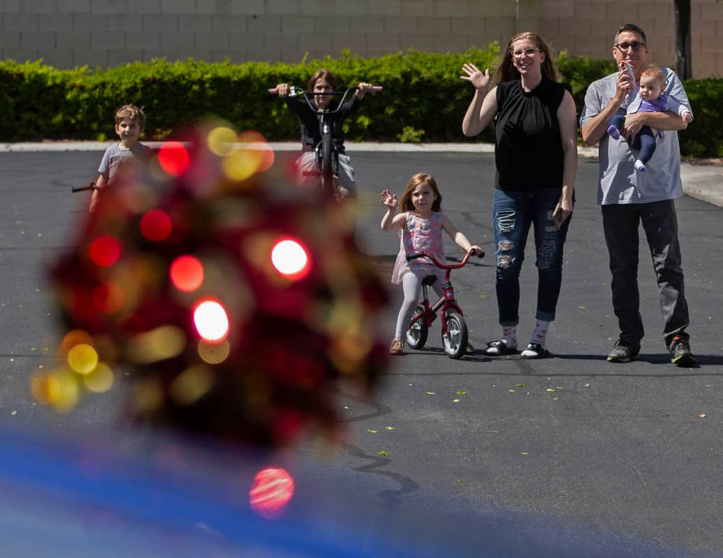 Las Vegas residents wave to teachers and staff from O’Roarke Elementary School who organ ...