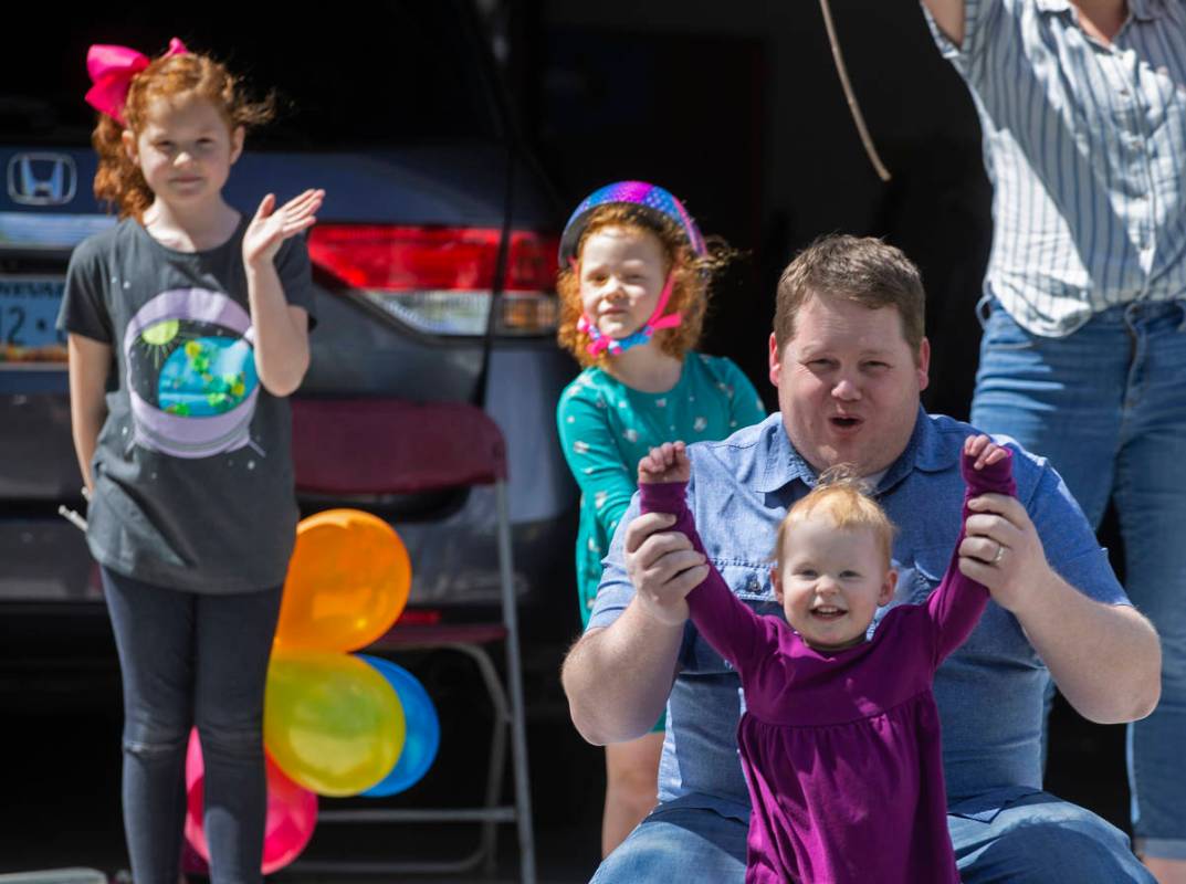 Las Vegas residents wave to teachers and staff from O’Roarke Elementary School who organ ...