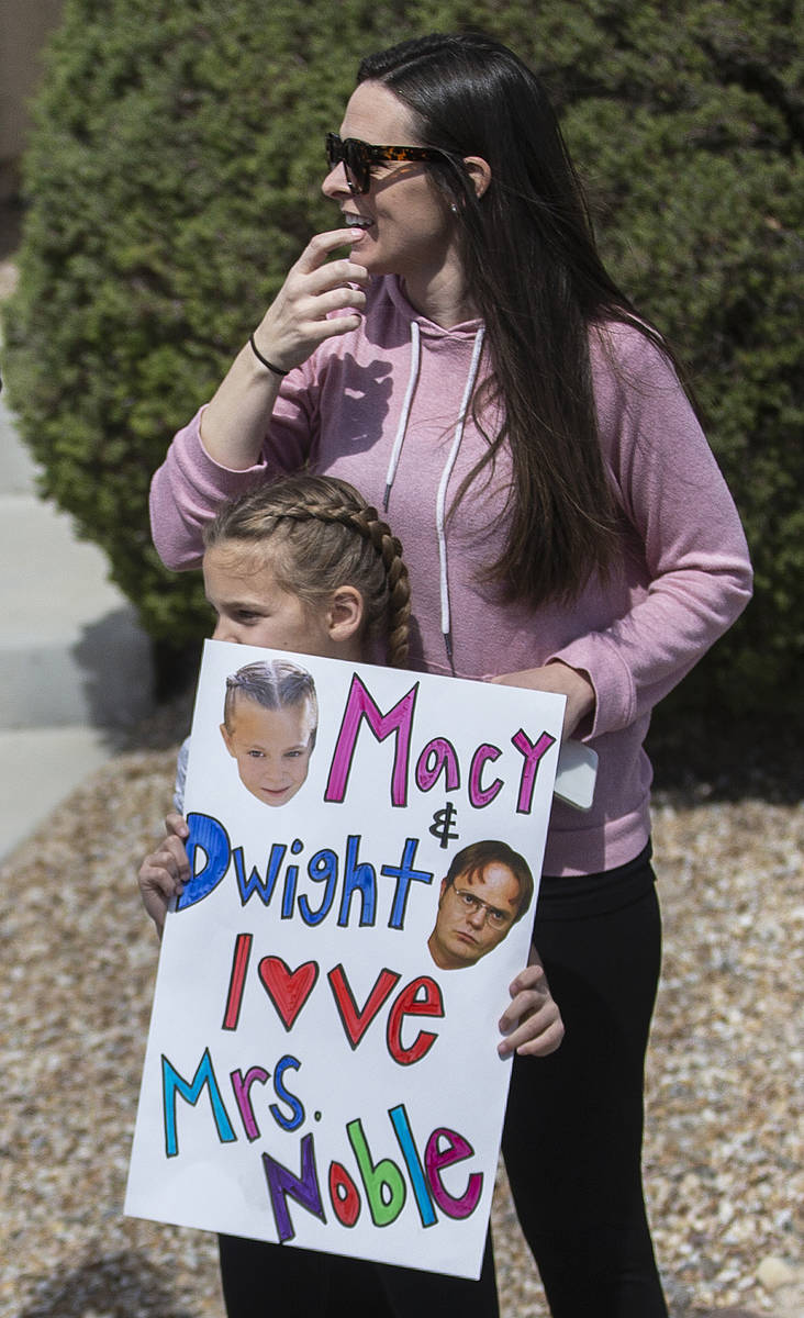 Las Vegas residents wave to teachers and staff from O’Roarke Elementary School who organ ...