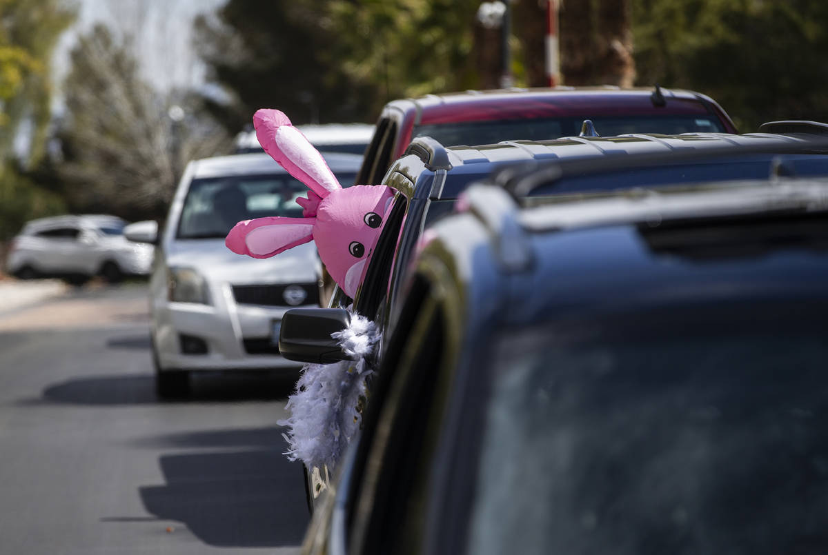 Teachers and staff from OՒoarke Elementary School make their way through neighborhoods wh ...