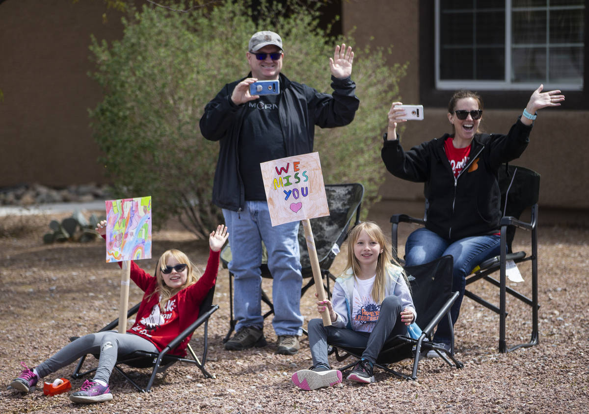 Las Vegas residents wave to teachers and staff from O’Roarke Elementary School who organ ...