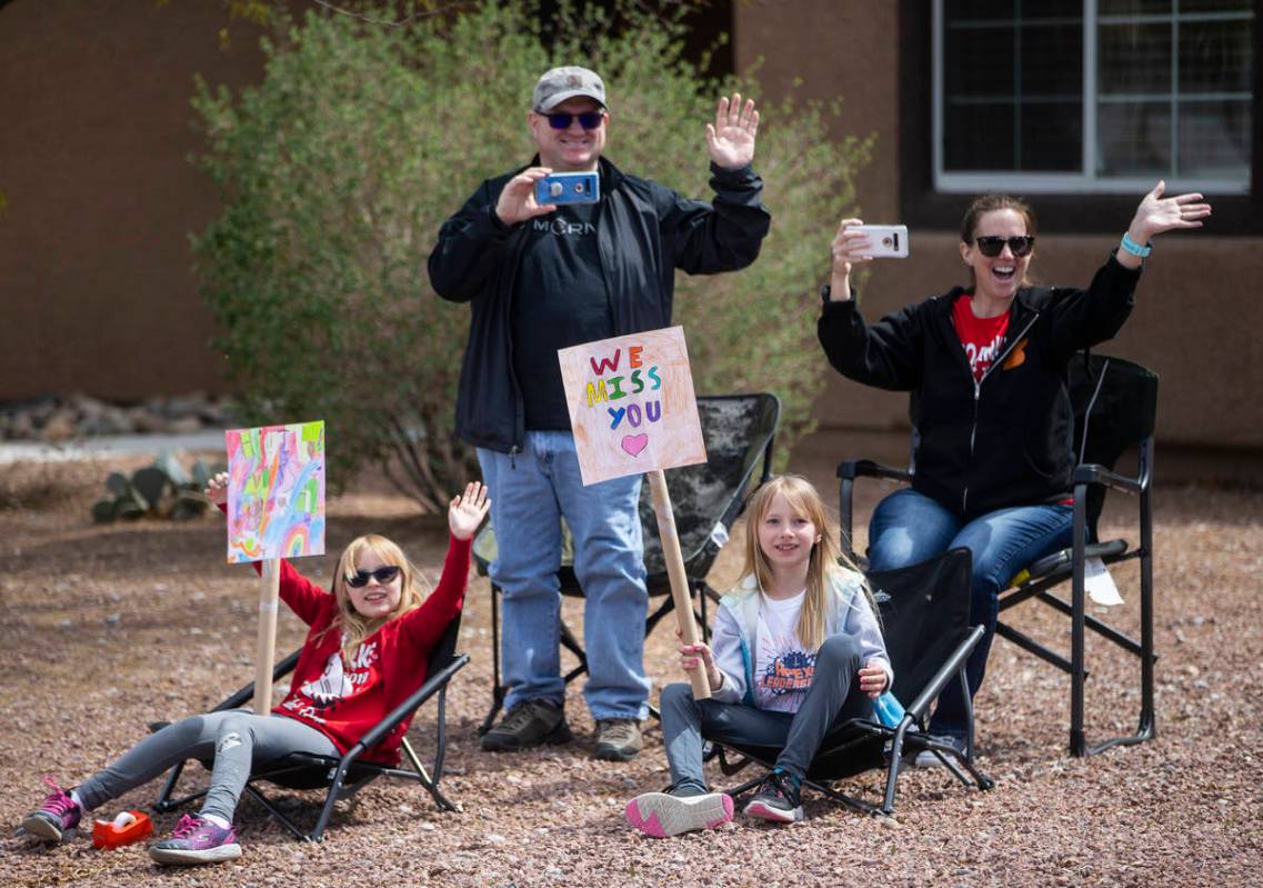 Las Vegas residents wave to teachers and staff from O’Roarke Elementary School who organ ...