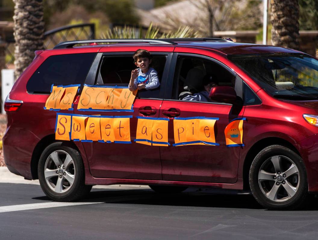 Las Vegas residents greet teachers and staff from OՒoarke Elementary School who organized ...