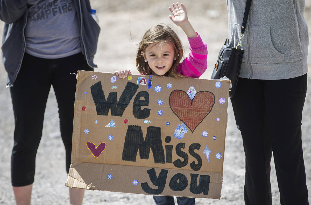 Las Vegas residents wave to teachers and staff from O’Roarke Elementary School who organ ...