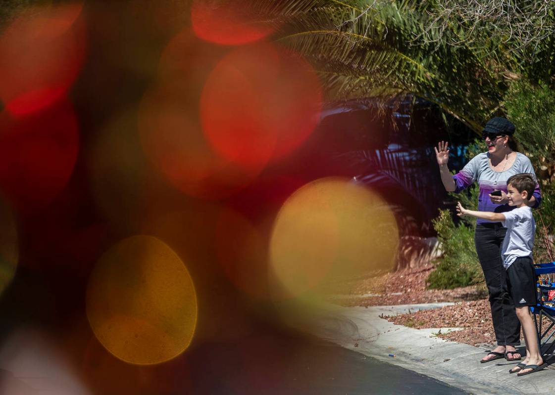 Las Vegas residents wave to teachers and staff from O’Roarke Elementary School who organ ...