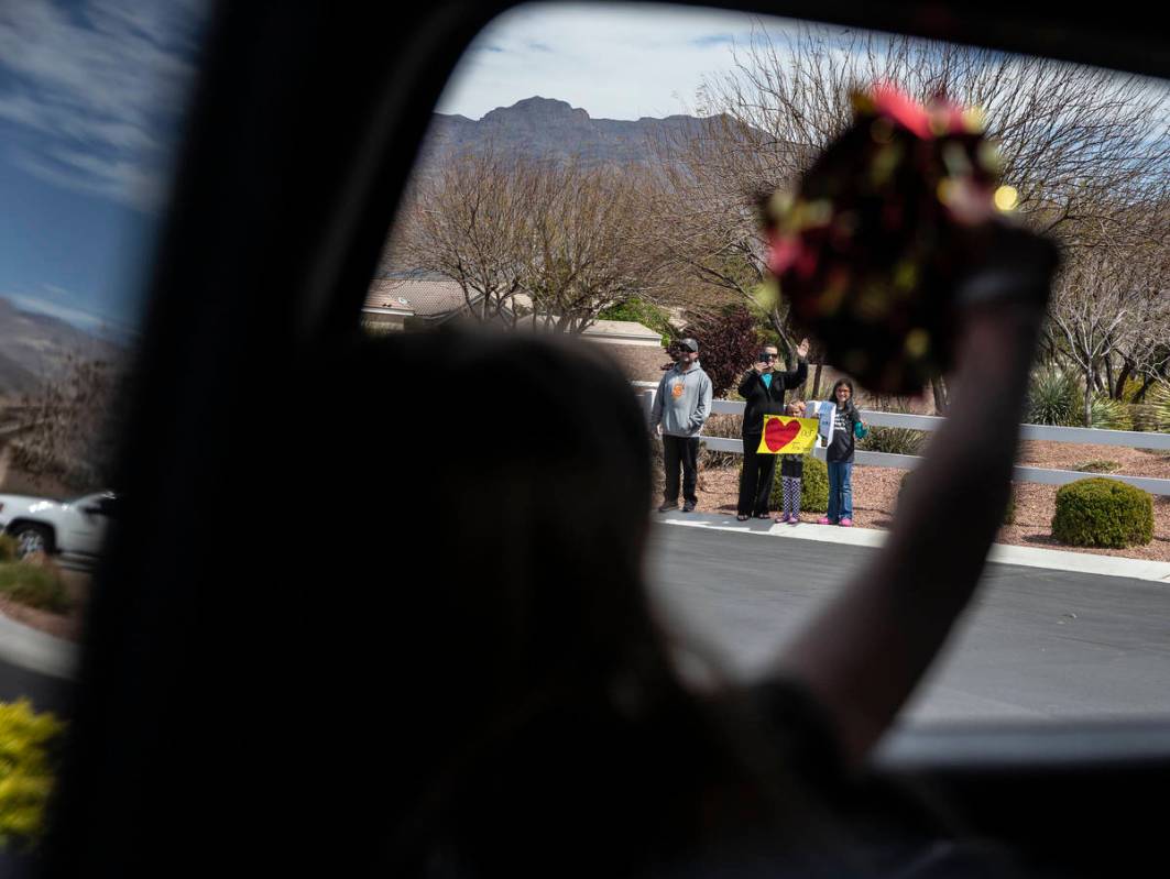 Las Vegas residents wave to teachers and staff from O’Roarke Elementary School who organ ...