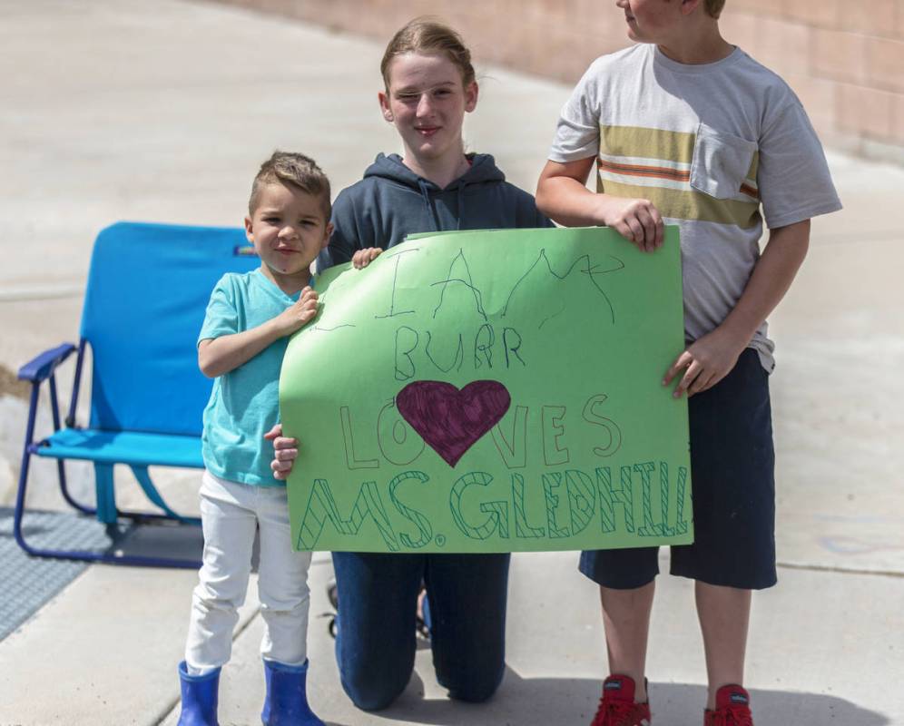 Las Vegas residents wave to teachers and staff from O’Roarke Elementary School who organ ...