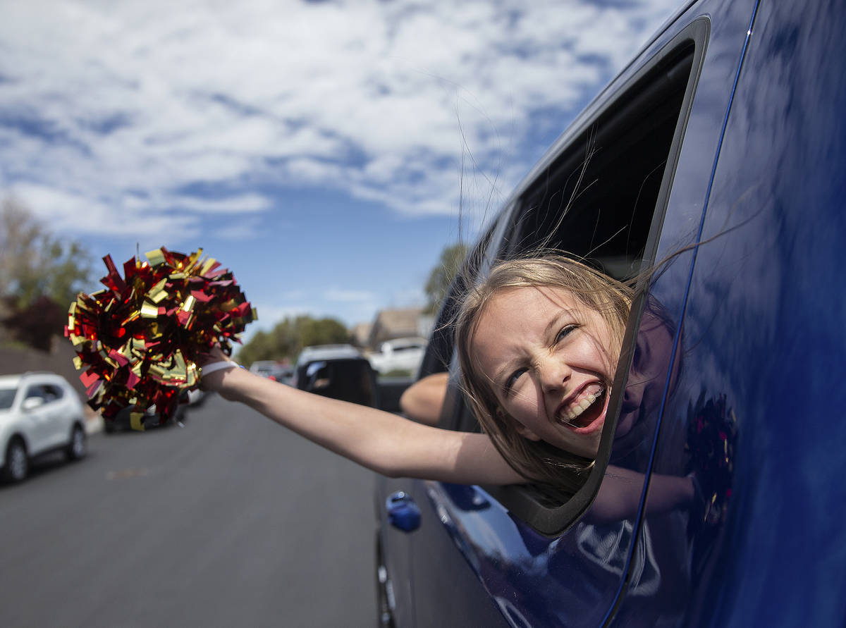 Ella Sproule, 11, waves from her mothers truck during a parade organized by O’Roarke Ele ...